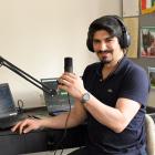 Radio presenter Amir Amini, of Dunedin, prepares another broadcast for Radio Toranj, which has...