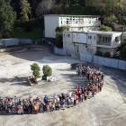 Arthur Street School pupils stand on the site where half their school has been demolished. PHOTO:...