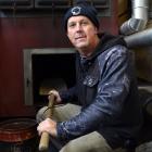 Caretaker Alister Wilden sits beside the broken boiler at Carisbrook School  yesterday. PHOTO:...