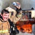 Invercargill City Station firefighter Harry Finnerty cools off after setting alight an Emerson St...