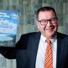 Finance Minister Grant Robertson poses with a copy of the Wellbeing Budget 2022 during a...