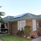 Corrine and Athol O'Connor's solar panels sit on the roof and power a majority of their day to...
