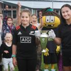 Half Moon Bay School pupil Tessa Helen holds the Women's Rugby World Cup trophy with Otago Spirit...