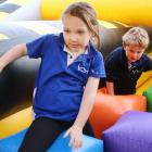 Indie Hewett (6) and Bobby Beattie make their way through the colourful obstacle course. PHOTO:...