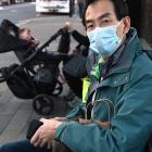Microbiologist and bus user Siong Loo, of Dunedin, waits for the Shiel Hill bus at Dunedin’s bus...