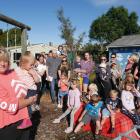 Outram Playcentre facilitator Julie Bathgate (front), holding Chloe (1), and other parents were...