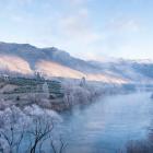 Mist hangs over the Clutha River looking towards the Clyde Dam in hoar frost conditions in Clyde.
