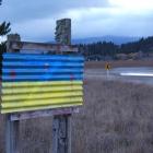 A makeshift sign bearing the colours of the Ukrainian flag has been repainted after it was...