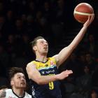 Otago Nuggets guard Darcy Knox heads to the basket to score, watched by Canterbury Rams player...