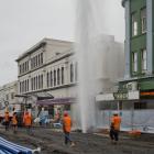 A high-pressure stream of water reaches towards the heavens in George St after a fire hydrant was...