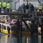 Firefighters pump water from Carey’s Bay-based fishing vessel Echo after it sank at its mooring...