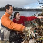 Ben Nevell and daughter Edie pick up rubbish at the Otago Harbour shore by Portsmouth Dr...