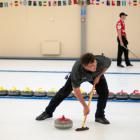 Sean Becker sweeps his stone on the second day of the New Zealand Curling mixed doubles qualifier...