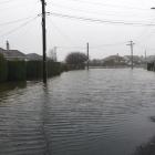 Flooding in Ashmore St, Halfway Bush this morning. Photo: Gerard O'Brien