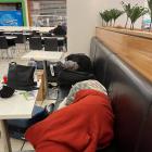 Passengers on the flight attempt to get some sleep in the airport. Photo: Supplied