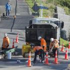Contractors make adjustments where a speed bump is being installed in Portobello Rd, Dunedin,...