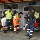 Omarama Volunteer Fire Brigade station officer Maurice Cowie wrings out his mop while (from left)...