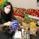 Social Worker Sarah Davis finishes loading a box of food at Presbyterian Support Otago Family...