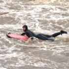 University of Otago student Toby Hille rides the current downstream at the river Leith. PHOTO...