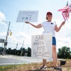A Trump supporter makes her feelings known about the FBI near the Trump National Golf Club in...