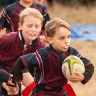 George Johnston (6), of Clutha Valley, charges ahead with the ball in the Rippa Rugby under-7s at...