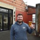 Noisy Brewing Company owner Chris Noye stands outside his new brewery and bar in Anzac Ave. PHOTO...