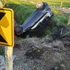 The driver of this vehicle was helped out of his car by a passing motorist. Photo: Supplied