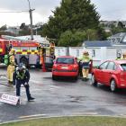 Police officers and firefighters attend the scene of a crash in Larnach Rd where one person was...