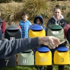 Tipping out a glass of tap water yesterday is Waihola resident Peter Smithies. Watching on (from...
