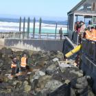 Contractors pour cement for new stairs beside the St Clair Hot Salt Water Pool in this June file...