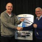 Tony Music handing back the Addington Raceway keys to Christchurch Greyhound Racing Club...