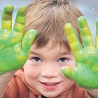 Flynn Brine 3, shows off his green hands during messy play at the Rangiora Playcentre.