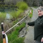 Kaitangata retiree Ann Manning points out erosion of the bank of the Clutha River she says has...