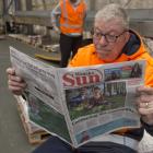 Allied Press dispatch worker Hughan Gould checks out a copy of the Wanaka Sun. PHOTO: GERARD O’BRIEN