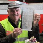 Southland Fire Service Museum president Les Costigan shows a photograph of the original memorial...