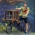 Pedals Dunedin founder Liam Harrison makes deliveries around the city yesterday. PHOTO: PETER...