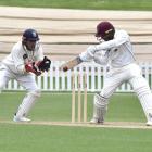 Northern District batsman Bharat Popli gets bat on ball as Otago Volts wicketkeeper Max Chu looks...