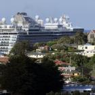 Cruise ship 'Majestic Princess' looms behind the houses of Port Chalmers as it leaves Dunedin on...