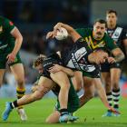 Joseph Manu of the Kiwis is enveloped by the Australian defence during World Cup semifinal in...