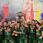 The Australian players celebrate with the trophy after their victory over Samoa at Old Trafford...