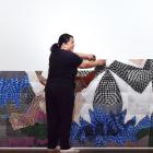 Artist Janet Lilo putting up her large photo mural at the Dunedin Public Art Gallery on Tuesday....