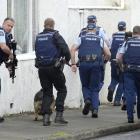 Armed police set off in pursuit of a man in Loyalty St. Photo: Gerard O'Brien
