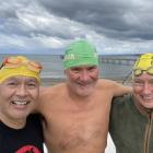 James White (centre), flanked by fellow swimmers Randy Perkins (left) and Rob McGlashan, gets...