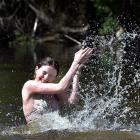 School pupils Rosa Smith and Ted Cottle (both 17) cool down at Outram Glen yesterday. Photos:...