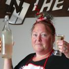 Kink n the Road Bistro & Bar cook Trudy Johnston holds samples of the discoloured tap water that...