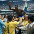 Brazil's Pele hoisted on the shoulders of his teammates after Brazil won the World Cup final...