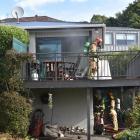 Personnel from Fire and Emergency New Zealand and police work at a house fire in Vauxhall...