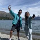 Hemi Cordell and Catrin Smith take their coffee and reusable cups down to the lake in Wanaka....