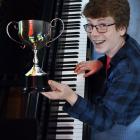 Dimitri Latton, of Macandrew Bay, holds his composition trophy yesterday. PHOTO: PETER MCINTOSH