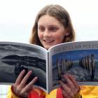 Checking out the recently published book of St Clair pole photographs is St Clair Surf Life...